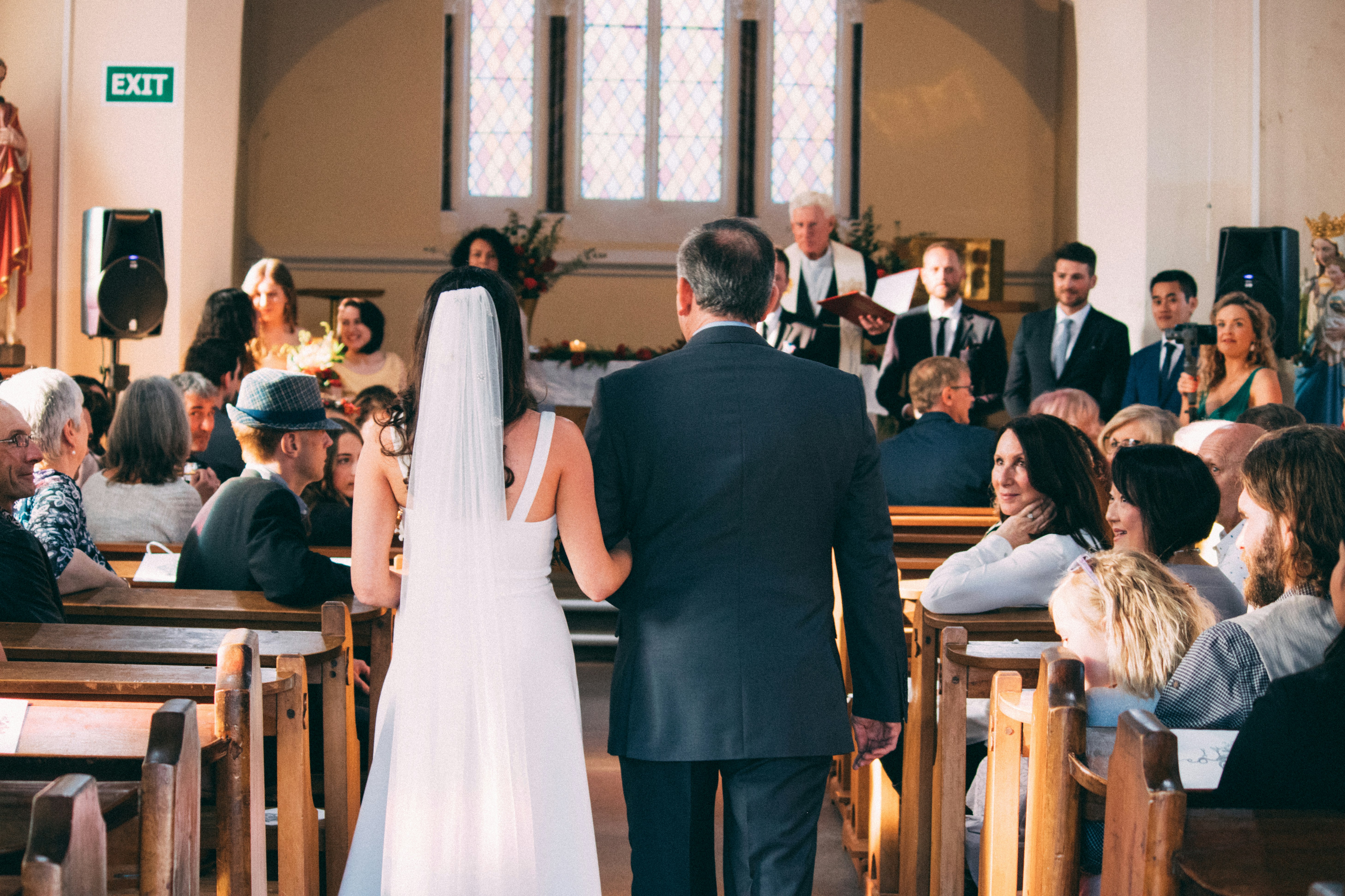 Church wedding processional with live music setting the tone as the wedding party enters.